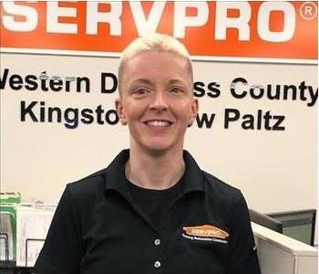 A photo of a smiling female SERVPRO employee in a black SERVPRO shirt