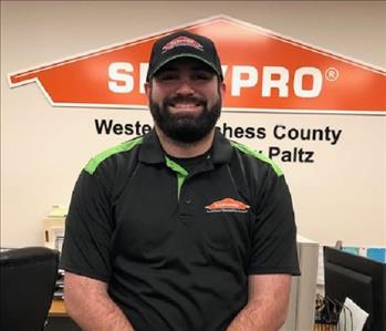 a profile photo of a smiling male employee in a black servpro shirt