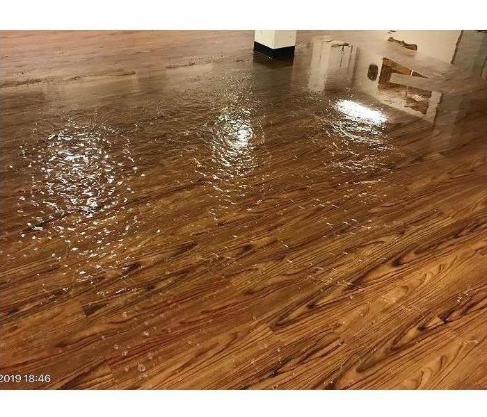 An inch of ice formed on a hardwood floor inside a commercial building