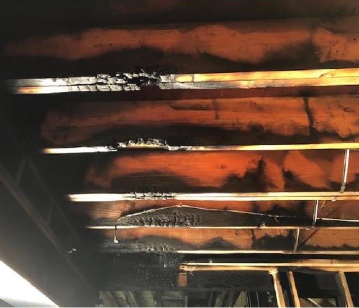 an image of burned and scorched rafters inside a home after a fire