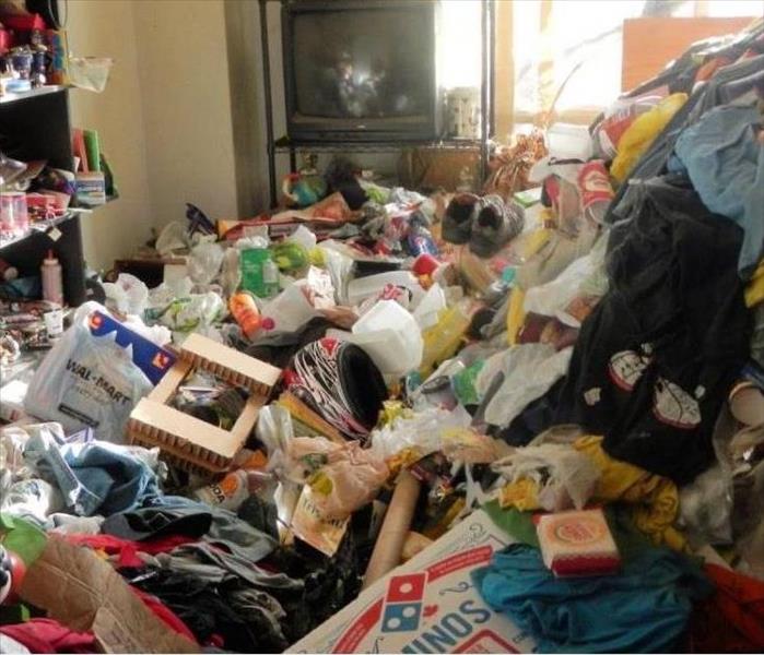 A room in a home filled with refuse and possesions