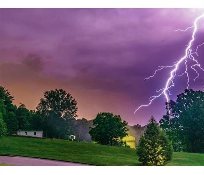 A vivid lightning strike very close to a home 