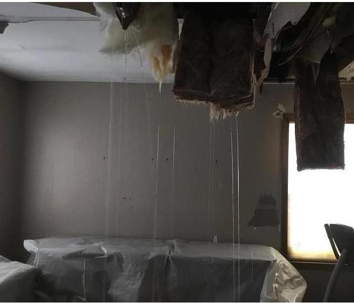 Burst water pipes causing a waterfall inside a home