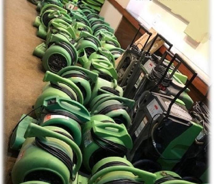 Large amounts of SERVPRO green equipment lined up at a commercial job 